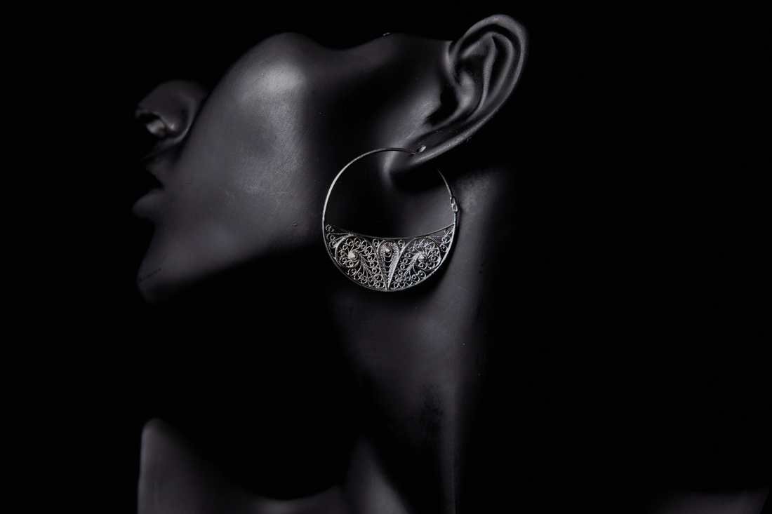 Woman wearing stylish hoop earrings at a wedding